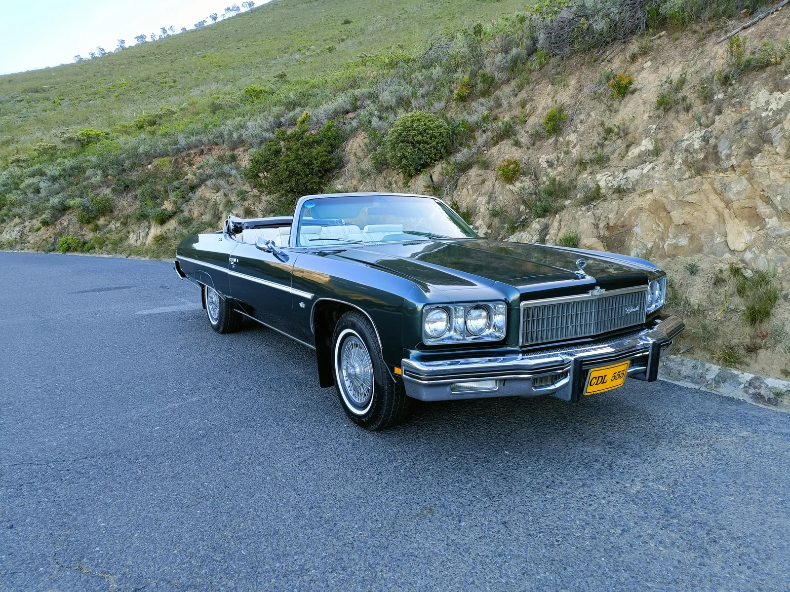 1975 Chevrolet Caprice Classic Convertible — hero shot on Cape Town mountain pass
